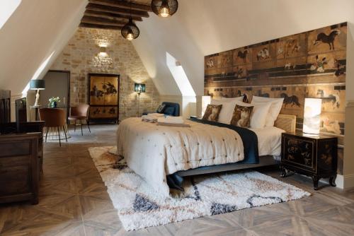 a bedroom with a large bed with a wooden headboard at Manoir de Laroque Delprat in Autoire