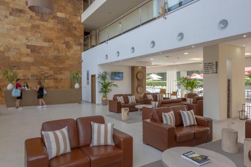 a lobby of a hospital with chairs and tables at Areias Village Beach Suite Hotel in Albufeira