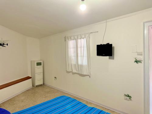 a bedroom with a bed and a tv on the wall at Il mare di Ognina in Siracusa