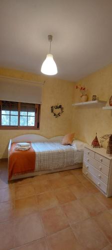 a bedroom with a large bed and a light at Casa Rural Rincones de Albares in Albares