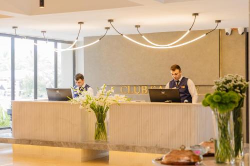 two people sitting at a counter with their laptops at Fun & Sun Club Saphire in Tekirova