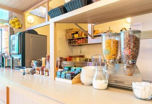 a kitchen with a counter with food in vases at B&B HOTEL Nantes Centre in Nantes