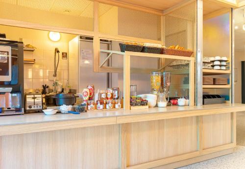 a kitchen with a counter with food items on it at B&B HOTEL Nantes Centre in Nantes