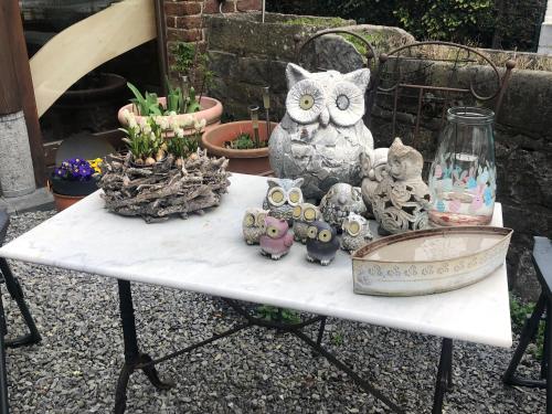 an owl figurines are sitting on a table at B&B La Grange in Durbuy