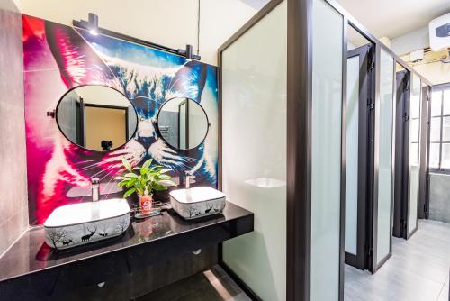 a bathroom with two sinks and a large mirror at Soleil Hostel in Ha Long