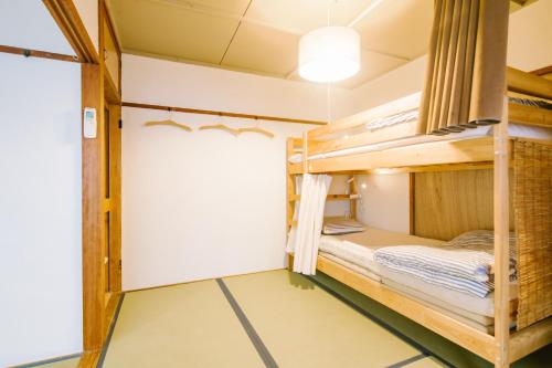 a room with bunk beds in a hostel at Guesthouse RICO in Wakayama