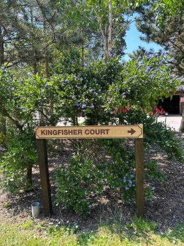 a sign in front of a garden with flowers at WILD DUCK HAVEN RESORT in Belton
