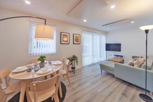 a dining room and living room with a table and a couch at Fantastic 2 Bedroom Apartment in Ashford in Ashford