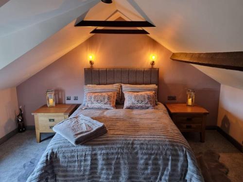 a bedroom with a large bed in a attic at Trinket - The Cliff Top Cottage in Sewerby