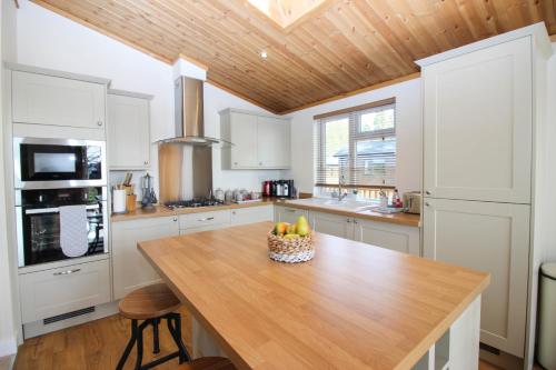 a kitchen with a table with a bowl of fruit on it at Hollicarrs - Forest Retreat in York