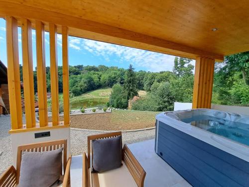 a jacuzzi tub on a patio with a view at Villa Magnolia in Sveti Martin na Muri