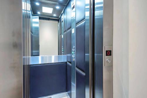 a bathroom with blue walls and a walk in shower at Welcome London - Trafalgar Townhouse in London