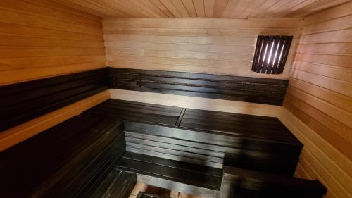 a room with benches in a sauna at Tihase studio apartment with sauna in Tallinn