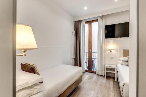 Postel nebo postele na pokoji v ubytování Hotel Sorrento City