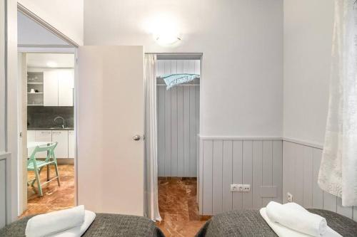 a bedroom with two beds and a kitchen at Park Guell Gaudi 2 bedroom Apartment in Barcelona