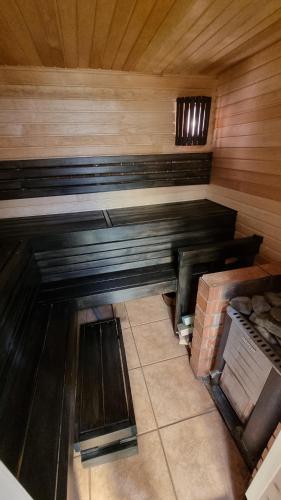 a room with a wooden bench in a room with a brick at Tihase studio apartment with sauna in Tallinn