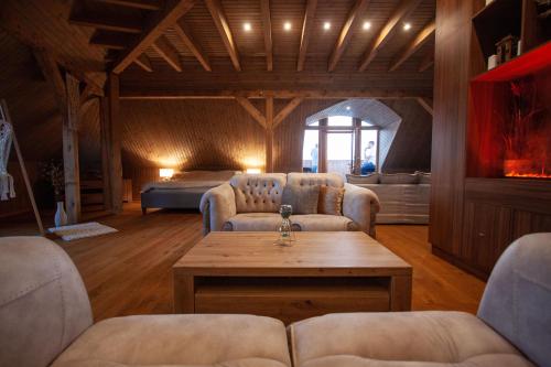a living room with two couches and a table at River View Apartment Old Riga in Rīga
