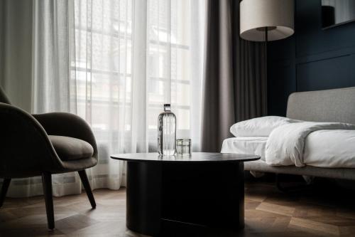a living room with a bottle on a coffee table at The Nox Hotel in Utrecht