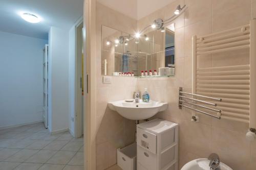 a bathroom with a sink and a toilet at Xenia Apartments - Spacious three-room apartment 10 min from Linate in Milan
