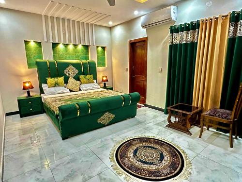 a bedroom with a green bed and a green couch at Homely Guest House and Hotels in Islamabad, Bahria Rawalpindi in Rawalpindi