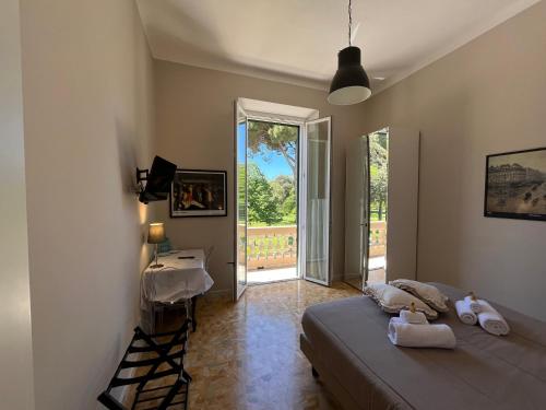 a bedroom with a bed and a desk and a window at Pura vida in Viareggio