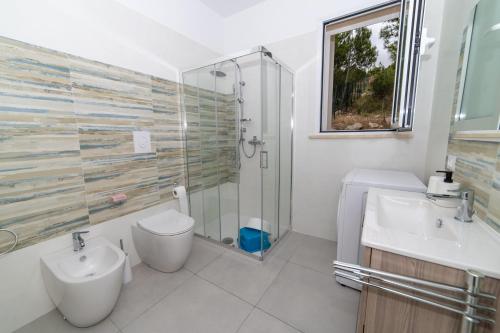 a bathroom with a toilet and a sink and a shower at Una prua sul mare in Nardò