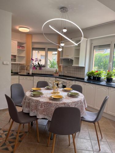 a kitchen with a table with chairs and a dining room at Garden villa in Budapest