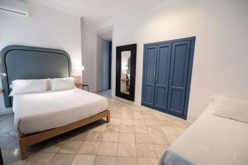 Postel nebo postele na pokoji v ubytování Apartahotel Siglo XIX