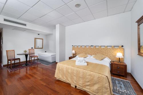 a bedroom with a large bed and a bathroom at Locanda Da Vittorio in Manerba del Garda