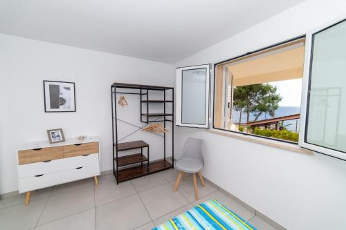 a white room with a desk and a window at Una prua sul mare in Nardò