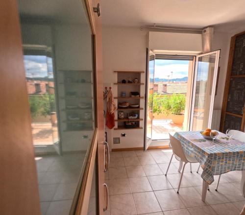 a dining room with a table and a glass door at Bellavista panoramic terrace Appartamento con terrazza zona Sant Orsola in Bologna