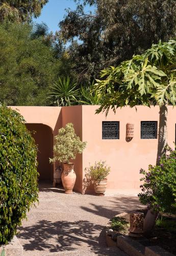 a building with two large vases in a yard at Dar Maktoub in Agadir