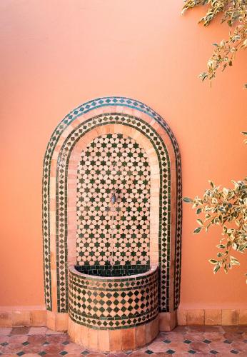 an ornate chair against a wall in a room at Dar Maktoub in Agadir