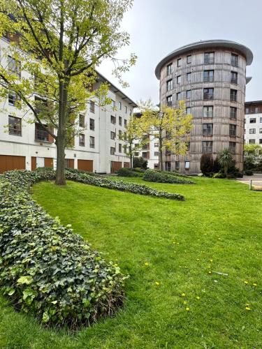 a park with a tree in front of a building at The Spencer Suite in Dublin