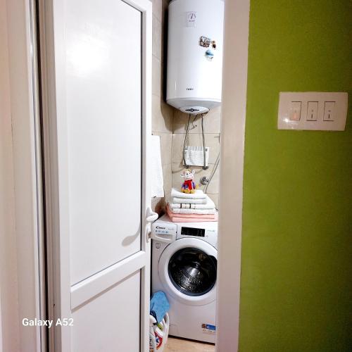 a laundry room with a washer and a washing machine at Apartman PAVLE in Pluzine
