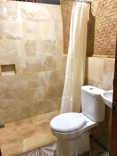 a bathroom with a toilet and a sink at Villa ChavaMinerva Bambu - Lembang in Cikareumbi 2