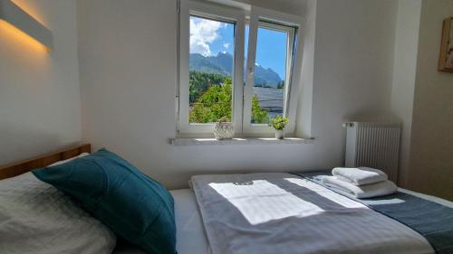 a bedroom with a bed and a window at Apartments Seventy Seven in Kranjska Gora
