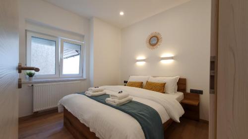 a bedroom with a large bed with towels on it at Apartments Seventy Seven in Kranjska Gora