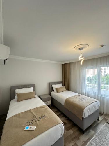 a hotel room with two beds and a window at Öztürk VIP in Pelitli