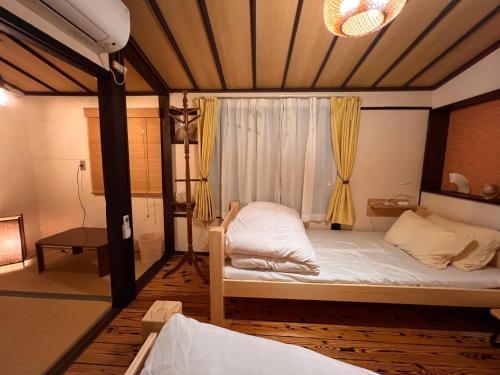 a bedroom with a bed with a canopy at Dormitory Omitsu in Nara