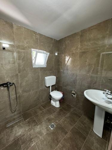 a bathroom with a toilet and a sink at Vila Dura in Ksamil