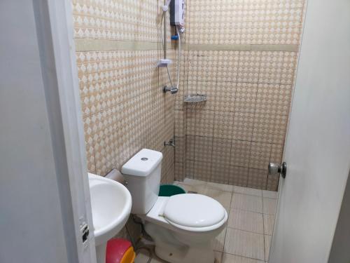 a bathroom with a toilet and a sink at Enamorado Studios in Angeles