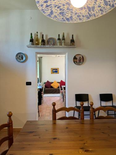 a room with a table and chairs and a living room at Affittacamere Ca' de Mazapedar in San Lorenzo