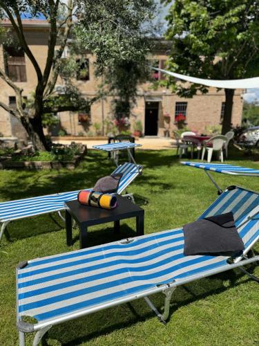 three blue and white benches sitting in the grass at Affittacamere Ca' de Mazapedar in San Lorenzo