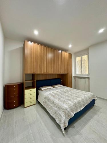 a bedroom with a large bed and wooden cabinets at Verso il Lago in Laveno-Mombello