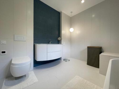 une salle de bain avec des toilettes blanches et un lavabo dans l'établissement Villa Brise des Pins, au Cannet