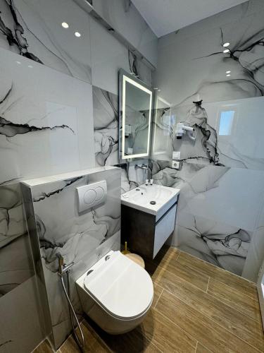 a bathroom with a toilet and a sink at Vila Dura in Ksamil
