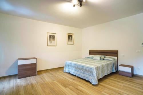 a bedroom with a bed and a ceiling fan at Cà Mandarein in Quattro Castella