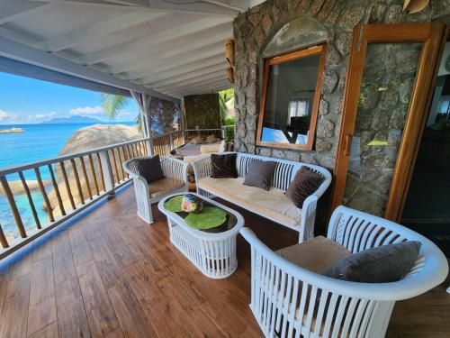 a balcony of a resort with chairs and a table at Marquise & Infinity villas in Glacis