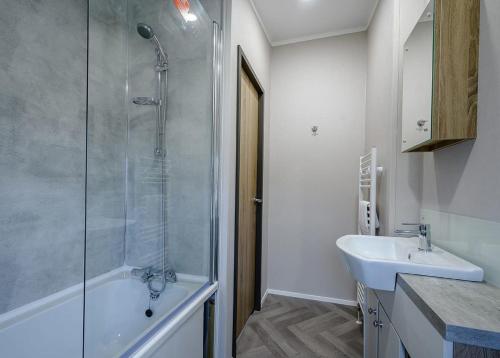 a bathroom with a shower and a sink at Green Meadows Country Park in Harker